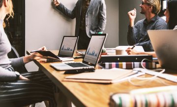 People in a board room holding a business meeting.