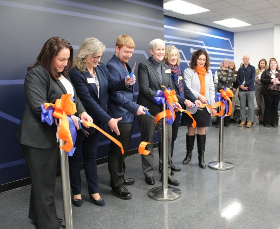 President Stephanie Nesbitt and members of the Utica University Community cut the ribbon on the new Cyber Range.