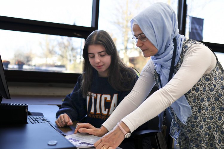 Physics Professor Hava Turkakin works with a student at the computer.